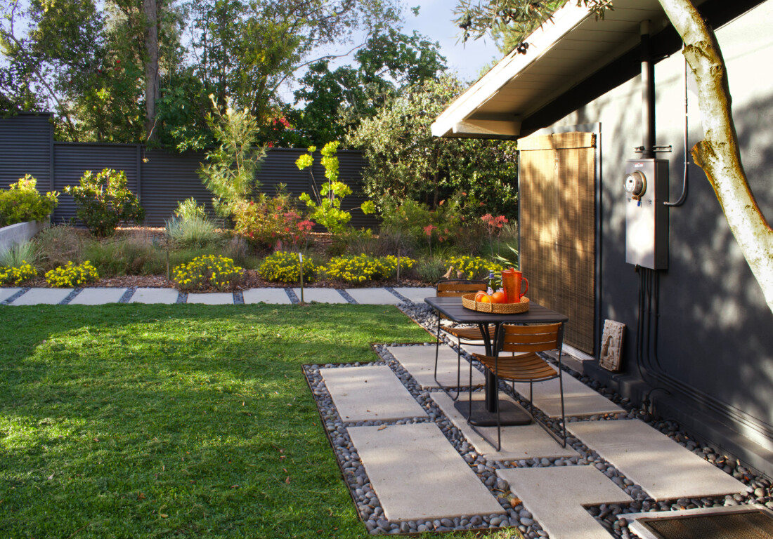 Modern concrete patio and walkway installation in residential backyard